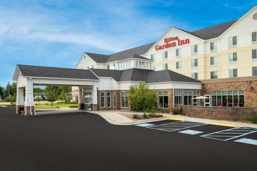 a hotel with a parking lot in front of it at Hilton Garden Inn Great Falls in Great Falls
