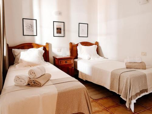 two beds in a room with towels on them at Casa Buna Colorada in Playa Blanca
