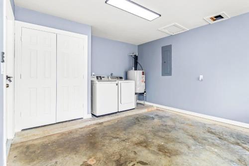 an empty room with white appliances and a door at Spacious 3BR Home Near SPI Beach & Restaurants in Port Isabel