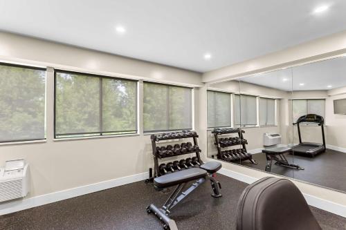 a gym with treadmills and chairs and windows at Best Western West Lebanon-Hanover in West Lebanon
