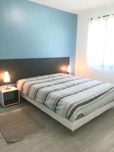 une chambre avec un grand lit et une fenêtre dans l'établissement Location appartement 3 pièces à 200 m de la gare 5 pers max, à Cormeilles-en-Parisis