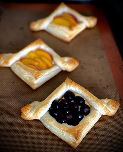 three pastries with fruit in them on a table at Bloom Farm Guesthouse in Mount Vision