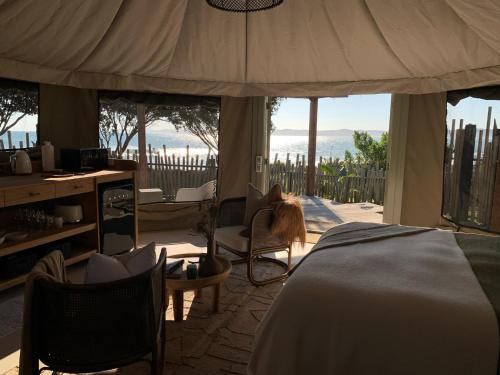 a bedroom with a bed and a view of the ocean at Te Whaanga Retreat & Spa in Raglan
