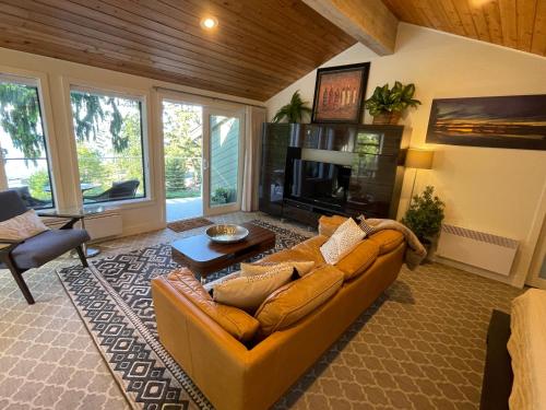 a living room with a couch and a fireplace at Tyee Beach Oasis Bed and Breakfast in Nanoose Bay