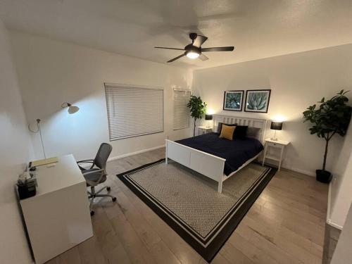 a bedroom with a bed and a ceiling fan at Pet Friendly Home Near Hospitals in Moreno Valley