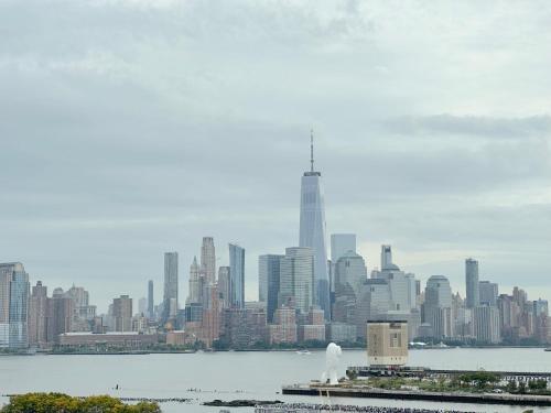a view of a city skyline with the oriental pearl tower at Luxury 2BR - Elevator-Gym-Laundry-10 Min to NYC in Hoboken