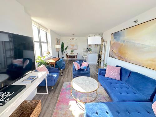 a living room with a blue couch and chairs at Luxury 2BR - Elevator-Gym-Laundry-10 Min to NYC in Hoboken