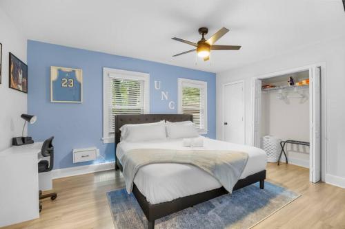 a bedroom with a bed with a blue wall at Half Off Prices! 2 Miles to Downtown Front Street! Free Parking! in Wilmington