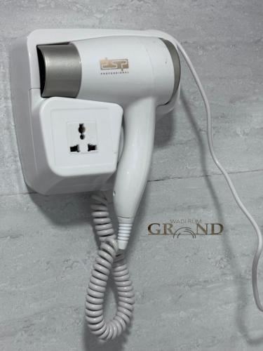 a white phone is plugged into a wall at Wadi Rum Grand in Wadi Rum