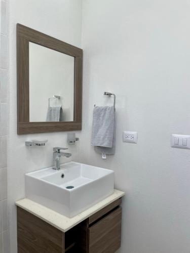 a bathroom with a white sink and a mirror at Private Room Bunk Bed Queretaro Entrance in Miranda