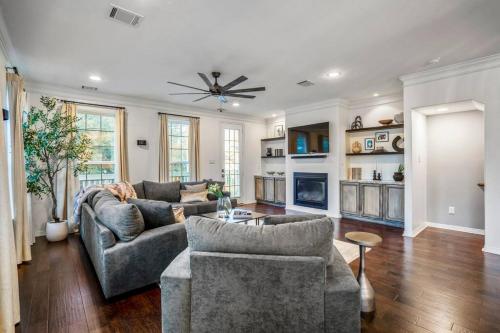 a living room with two couches and a fireplace at Vintage Hollywood Theater House in East Downtown in Houston