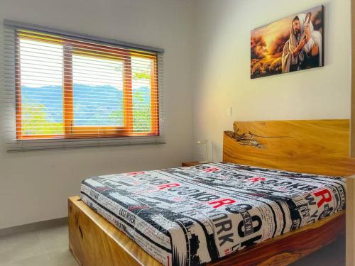 a bedroom with a wooden bed in a room at 15 mins to Jardín Spacious & Convenient House in Los Andes
