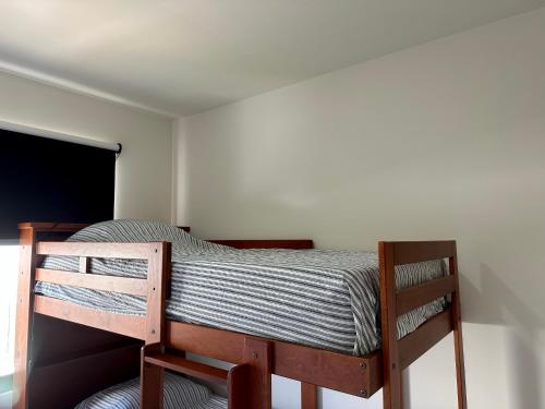 a wooden bunk bed in a room with a window at Private Room Bunk Bed Queretaro Entrance in Miranda