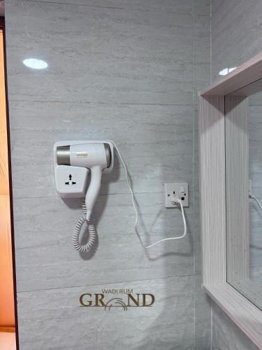 a picture of a phone on a wall at Wadi Rum Grand in Wadi Rum