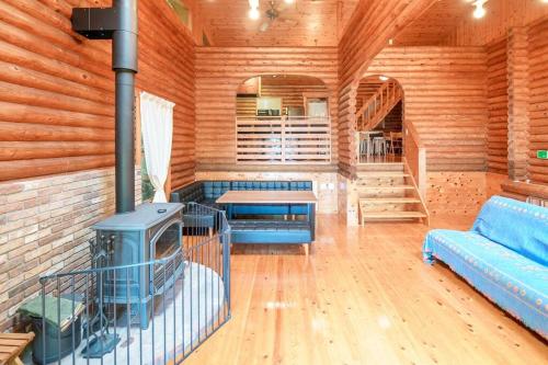 a living room with a stove in a log cabin at The Villas atami LOG cottage in Atami