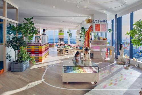 a rendering of a room with plants and a table at RISONARE Osaka in Osaka