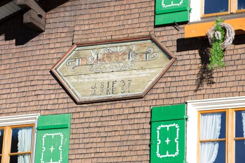 a sign on the side of a building at Gästehaus Fritz in Mittelberg