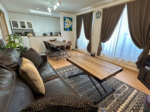 a living room with a couch and a table at Laulea in Yaka