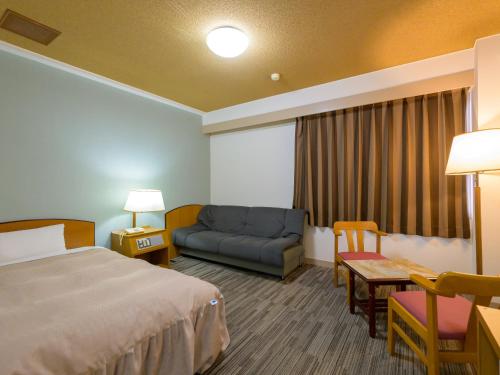 Postel nebo postele na pokoji v ubytování Hisai Green Hotel