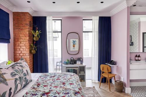 a bedroom with a bed and a mirror at Pineapple House Boutique Hotel in Cape Town