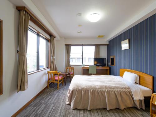 Postel nebo postele na pokoji v ubytování Hisai Green Hotel