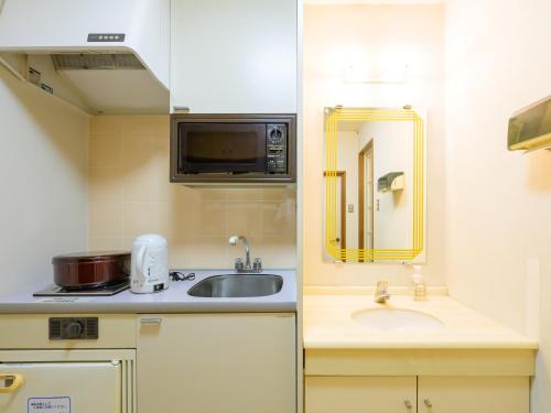 Kuchyň nebo kuchyňský kout v ubytování Hisai Green Hotel