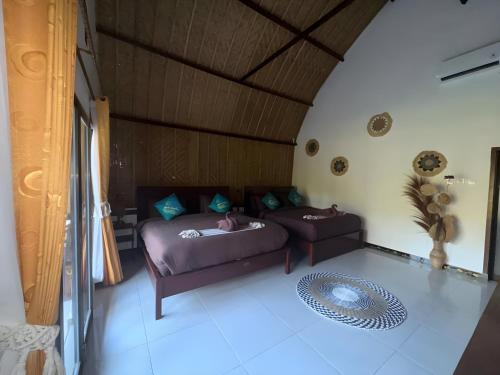 a living room with a bed and a couch at Meket Bungalows in Nusa Penida