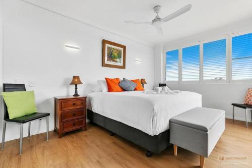 a bedroom with a large bed and a chair at Penthouse on Woorim in Woorim