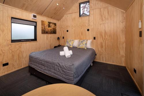 a bedroom with a bed in a small room at Queenstown Top 10 Holiday Park in Queenstown