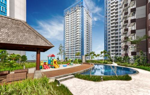 a playground in a city with tall buildings at Delipark Mall 2 Bedrooms 1 Bathroom 4-6 Pax Liberty Tower Level 9 in Medan
