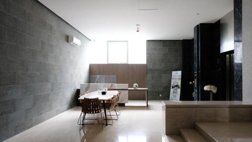 a dining room with a table and chairs at Good Location and New Studio at The City Square Surabaya Apartment By Travelio in Bendulmrisi