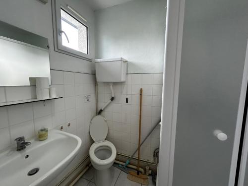 une salle de bain blanche avec des toilettes et un lavabo dans l'établissement Studio avec jardin commun et WIFI proche centre-ville et Thermes - FR-1-541-120, à La Roche-Posay