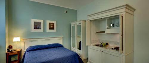 a blue bedroom with a bed and a sink at Santa Giulia Hotel e Residence Torino in Turin