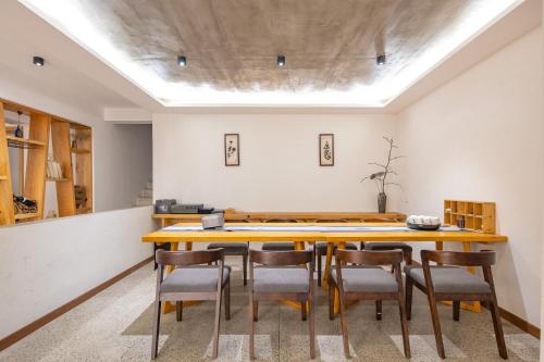 a dining room with a wooden table and chairs at Yunshan Villa in Huangshan Scenic Area
