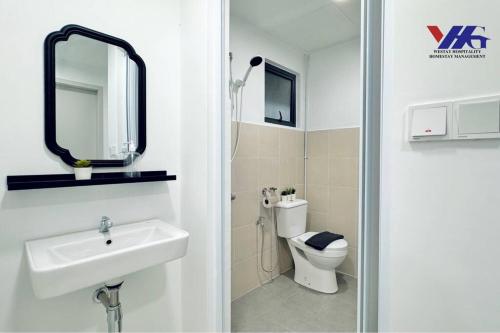 a bathroom with a sink and a toilet and a mirror at Arena Suite with Netflix KLIA in Sepang