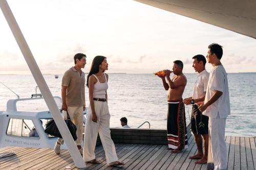 a group of people standing on the deck of a boat at Park Hyatt Maldives Hadahaa in Gaafu Alifu Atoll