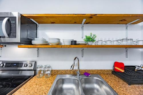 a kitchen with a sink and a microwave at Oceanview Escape Private Pool Villa in Arecibo