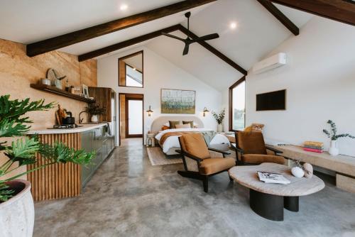 a bedroom with a bed and a living room at Oak Studio at Kavillo in Mudgee