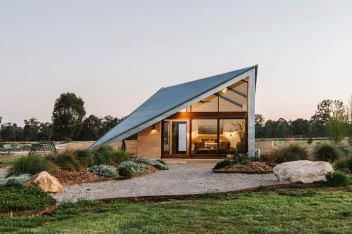 a glass house with a gambrel roof at Oak Studio at Kavillo in Mudgee