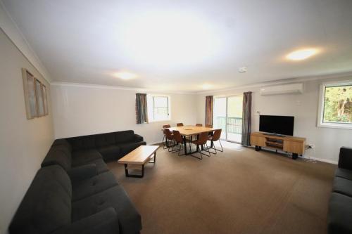a living room with a couch and a table at Sunseekers at Hat Head - 44 Bay Street in Hat Head