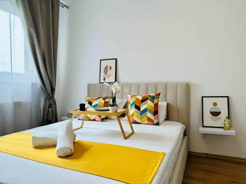 a bedroom with a bed with a table on it at Joy City Stay Forest 84 in Timişoara