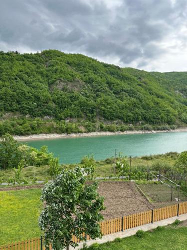 a view of a body of water with a fence at Guest House Artjoni Fierze in Fierzë