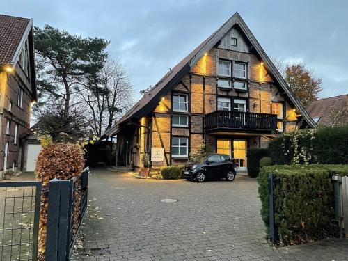 a black car parked in front of a house at Das Landhotel zur Mühle in Münster
