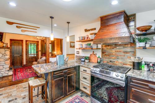 a kitchen with a stove and a living room at Dreamy Damascus Cabin about 1 Mi to Appalachian Trail in Damascus
