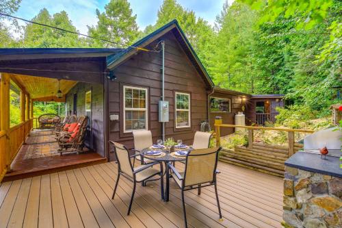 a cabin with a table and chairs on a deck at Dreamy Damascus Cabin about 1 Mi to Appalachian Trail in Damascus