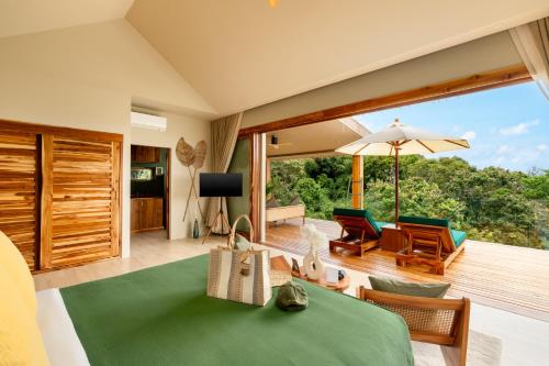 a room with a view of a living room at Wild Cottages Elephant Sanctuary Resort in Amphoe Koh Samui