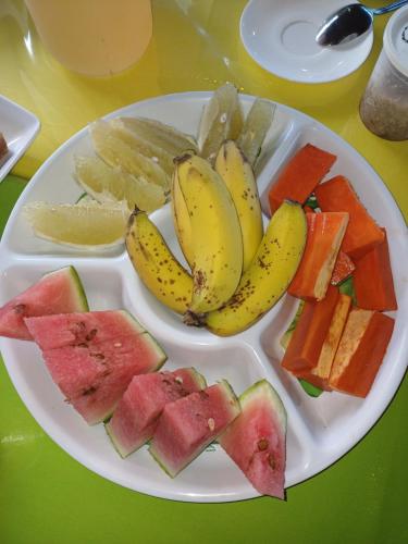 a plate of fruit and vegetables on a table at Pitake Lodge 1 in Nuku Hiva