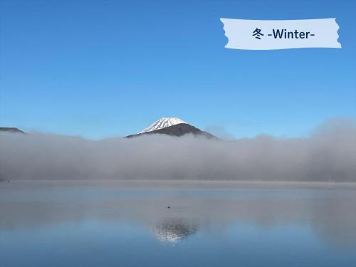 a mountain in the middle of a body of water at Hakone Hotel in Hakone