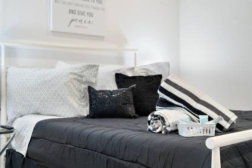 a bed with pillows on it in a room at Lovely Apt 5mins from Big Tex Free Prk in Dallas