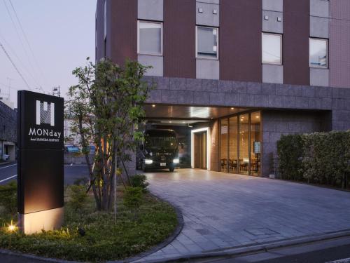 a bus is parked in front of a building at hotel MONday Haneda Airport in Tokyo